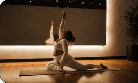 Pregnant woman stretching in a yoga studio