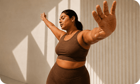 Woman stretching in sunlight during a wellness practice